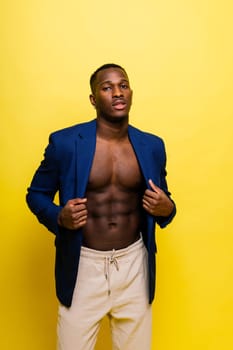 African black man model in a blue suit topless, studio background