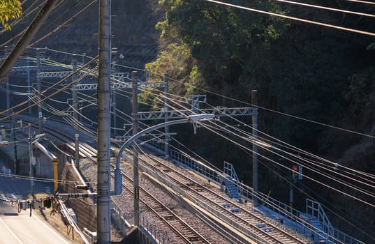 High voltage electrical wires over empty train tracks. High quality photo