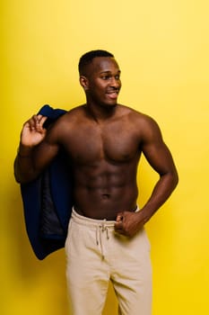 African black man model in a blue suit topless, studio background