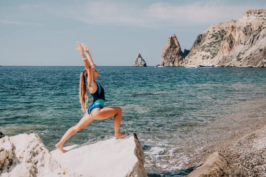 Woman sea yoga. Back view of free calm happy satisfied woman with long hair standing on top rock with yoga position against of sky by the sea. Healthy lifestyle outdoors in nature, fitness concept.