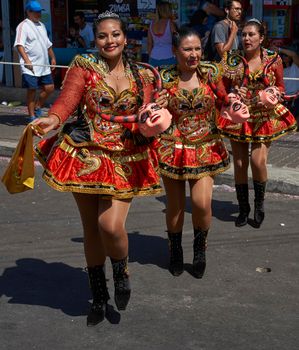 ARICA, CHILE - JANUARY 23, 2016: Young women performing the Diablada (dance of the devil) as part of the Carnaval Andino con la Fuerza del Sol in Arica, Chile. The dance originates in Oruro, Bolivia