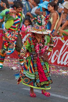 Arica, Chile - January 23, 2016: Tinkus dancing group in colourful costumes performing a traditional ritual dance as part of the Carnaval Andino con la Fuerza del Sol in Arica, Chile.