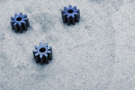 Small gears close up on a gray background, macro photo
