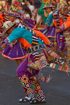 Arica, Chile - January 23, 2016: Tinkus dancing group in colourful costumes performing a traditional ritual dance as part of the Carnaval Andino con la Fuerza del Sol in Arica, Chile.