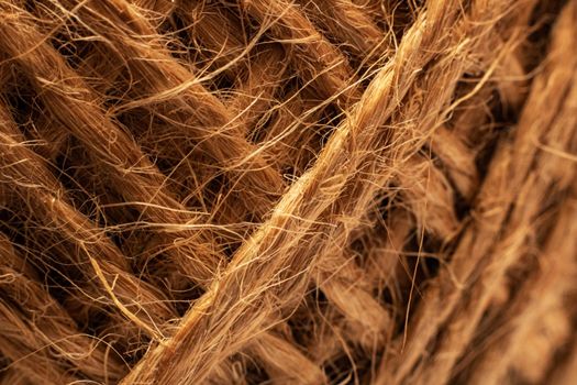 Skein of twisted yellow rope close up, macro photo