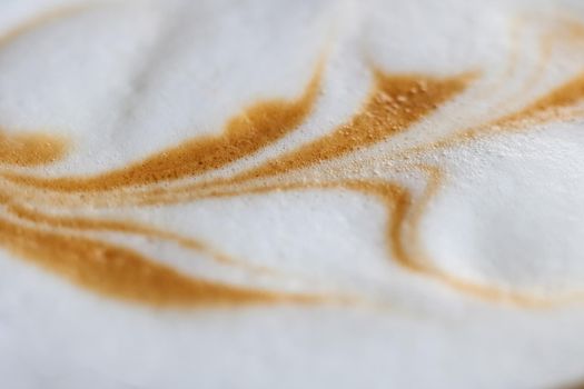 Drawing on white crema from coffee close up, macro photo