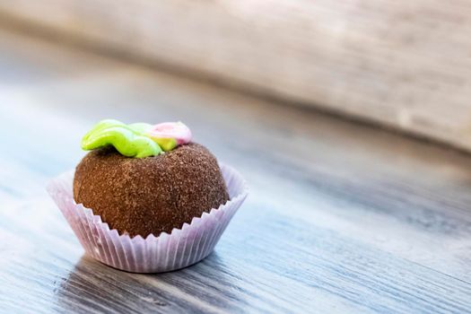 Round chocolate cake on a wooden table, copy space