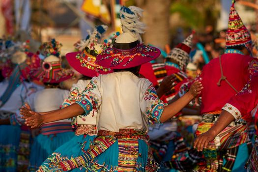 Arica, Chile - January 23, 2016: Tinkus dancing group in colourful costumes performing a traditional ritual dance as part of the Carnaval Andino con la Fuerza del Sol in Arica, Chile.