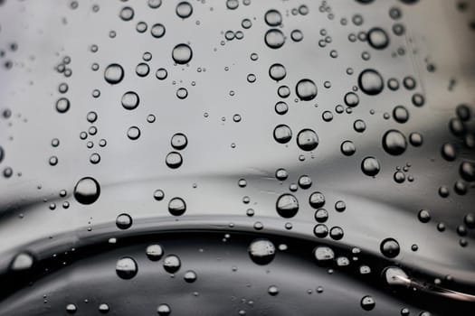 Bubbles in water on a gray background close up