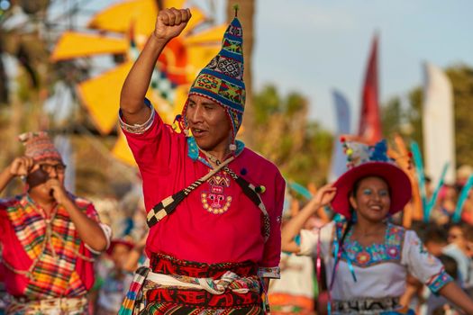 Arica, Chile - January 23, 2016: Tinkus dancing group in colourful costumes performing a traditional ritual dance as part of the Carnaval Andino con la Fuerza del Sol in Arica, Chile.