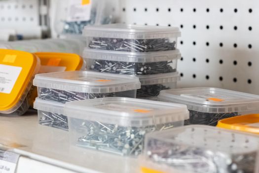 Boxes with nails on the shelf in the store close up