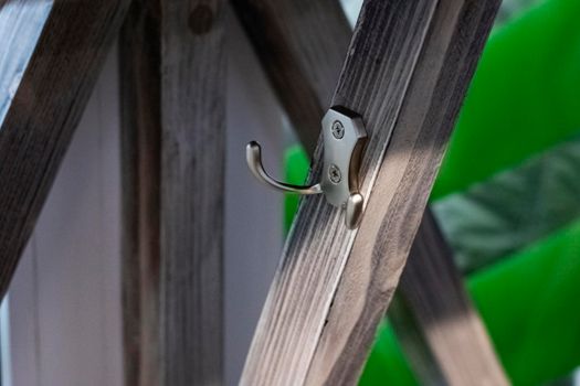 Clothes hook on a wooden wall close up