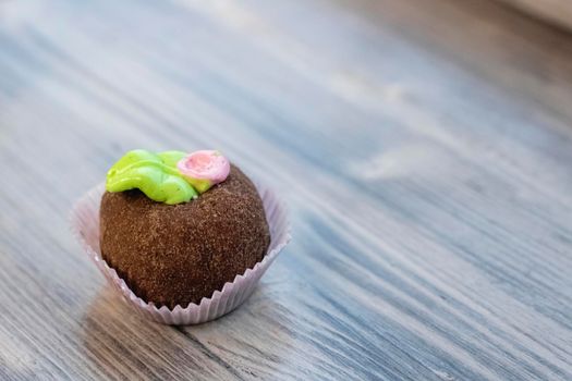 Round chocolate cake on a wooden table, copy space