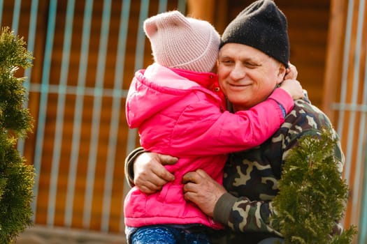 Senior man with his granddaughter. Child and grandpa outdoors. Benefits of getting older.