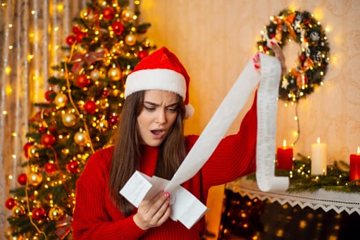 Girl spent a lot of money on presents at Christmas, looking through the receipt of purchases