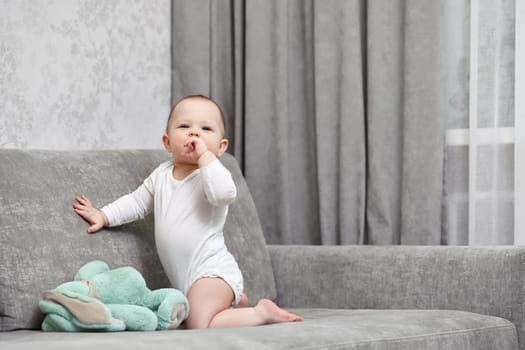 little child girl playing with soft toy bunny at home.