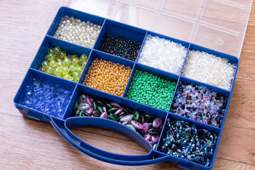 Colorful beads in containers close up, handicrafts, macrophoto
