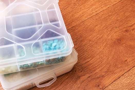 Small storage containers on a wooden floor close up