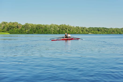 Team of two teenage boys kayaking on river. Active youth lifestyle, water sports, kayak, canoe