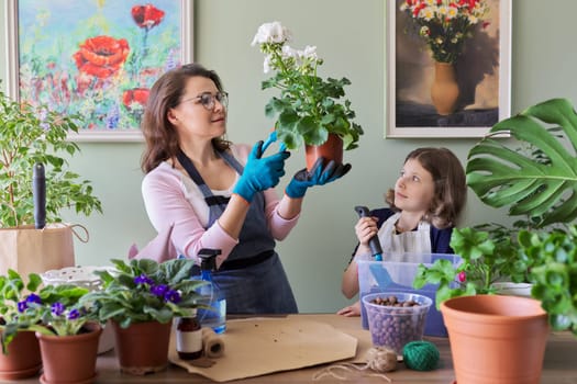 Mother and daughter child plant potted plants, flowers. Hobbies and leisure, care, family, houseplant, home potted friends concept