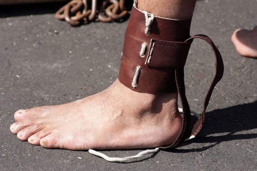 bare foot tied with shackles as penance in holy week. High quality photo