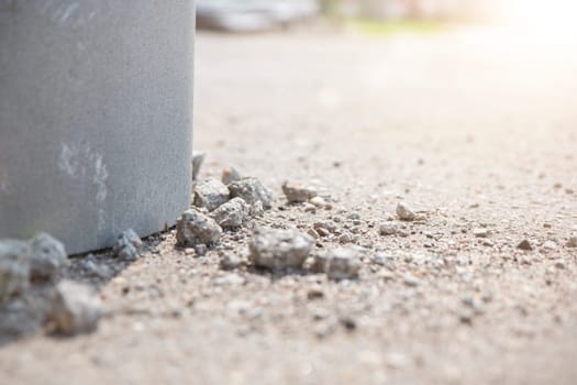 The emergency state of the building, the foundation of the old building is crumbling, pieces of old crumbling concrete lie on the asphalt, violations in the construction of buildings