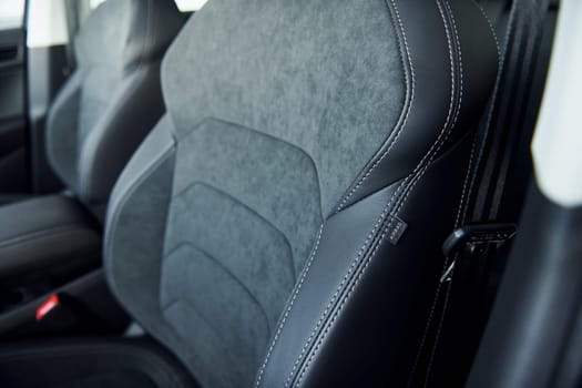 Comfortable seats. Close up focused view of brand new modern black automobile.