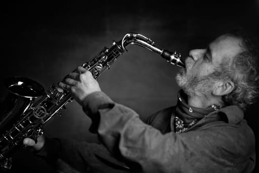 Saxophone player Saxophonist playing jazz music instrument Jazz musician playing sax alto, Profile shot of a musician playing a saxophone isolated on black background, High quality photo