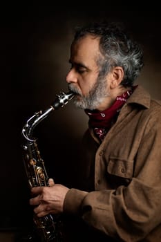 Saxophone player Saxophonist playing jazz music instrument Jazz musician playing sax alto, Profile shot of a musician playing a saxophone isolated on black background, High quality photo