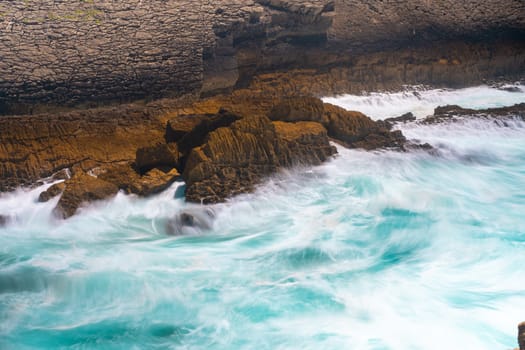 Atlantic ocean. Stormy summer day Big sea wave on rocky beach. Beaty in nature. Dramatic sea view. Long exposure