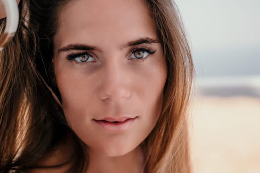 Happy woman portrait in cafe. Boho chic fashion style. Outdoor photo of young happy woman with long hair, sunny weather outdoors sitting in modern cafe