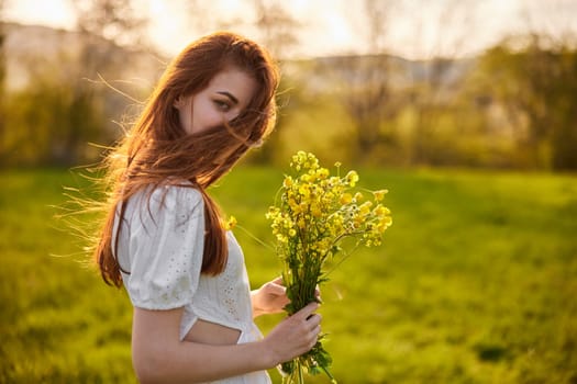 the woman is depicted in the countryside with a bouquet of yellow flowers. High quality photo