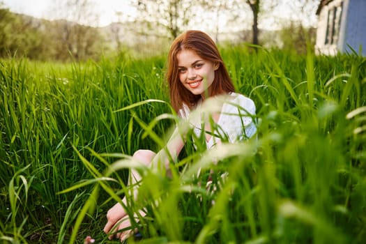 sunny summer day, a beautiful young woman lying on the grass. High quality photo