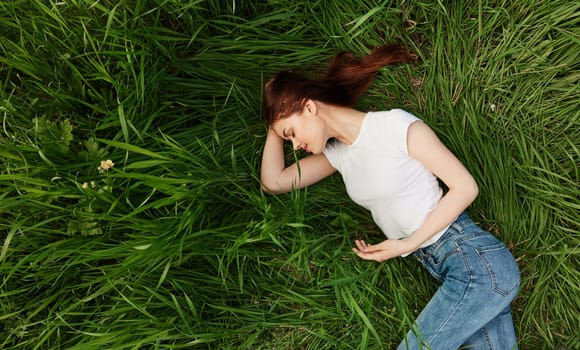 calm, peaceful woman falls asleep in tall grass. High quality photo