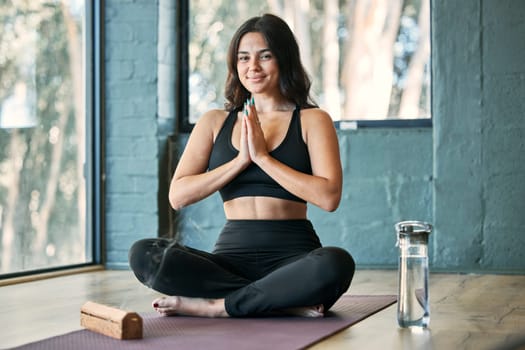 Namaste, yoga and portrait smile of woman in gym for health, wellness and exercise. Pilates, meditation and happy female yogi with prayer hands for training, exercising and meditate with incense