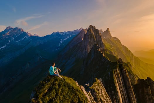 Schaeffler mountain ridge swiss Alpstein, Appenzell Switzerland, a ridge of the majestic Schaeffler peak by Berggasthaus Schafler, Switzerland. man in the mountains during sunset