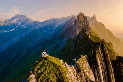 Schaeffler mountain ridge swiss Alpstein, Appenzell Switzerland, a ridge of the majestic Schaeffler peak by Berggasthaus Schafler, Switzerland. women in the mountains during sunset Ebenalp