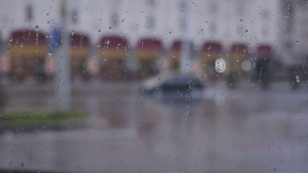 Drops of water on the glass of a cafe in the city