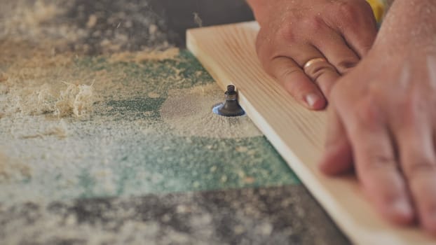The milling machine processes the board