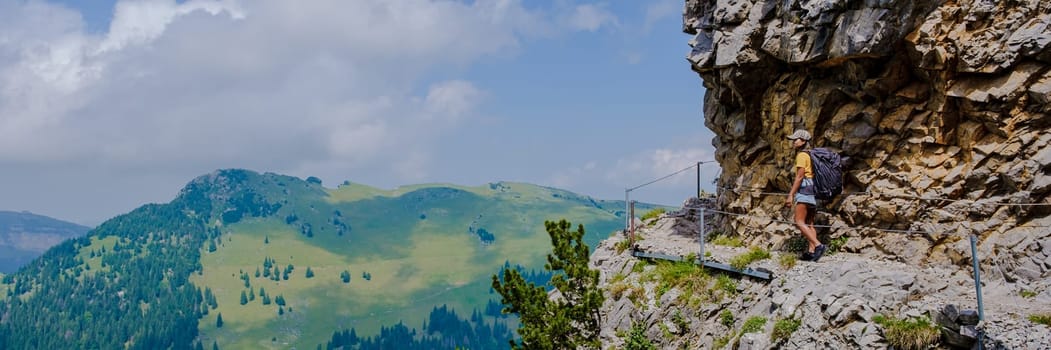 Asian women hiking in the Swiss Alps mountains during summer vacation with a backpack and hiking boots. woman walking on the Saxer Lucke path