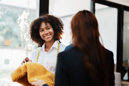 Multi ethnic young teen african american and asian woman fashion designer stylish and friend working at fashion Business studio.