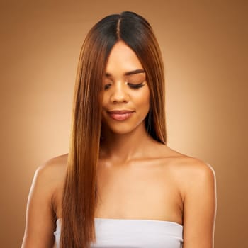 Hair care, straight and beauty of woman in studio for growth and color shine or healthy texture. Aesthetic female face for natural makeup cosmetics, hairdresser or salon mockup on a brown background.