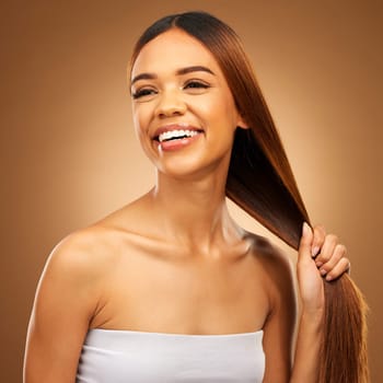 Haircare, smile and woman with strong straight hair in hand and studio space with texture and salon shine. Beauty model, healthy hairstyle and natural keratin product promotion on brown background