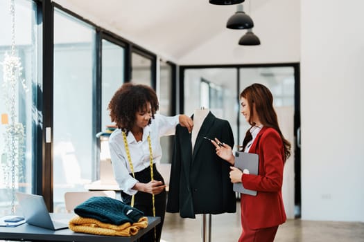 Multi ethnic young teen african american and asian woman fashion designer stylish and friend working at fashion Business studio.