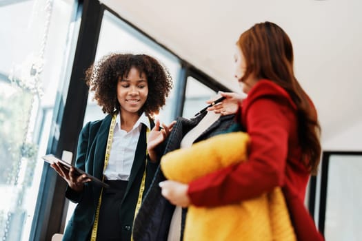 Multi ethnic young teen african american and asian woman fashion designer stylish and friend working at fashion Business studio.