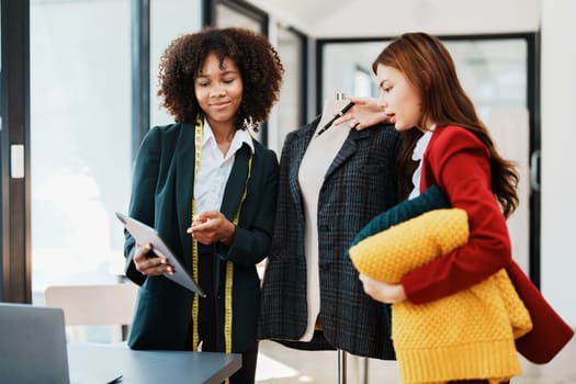 Multi ethnic young teen african american and asian woman fashion designer stylish and friend working at fashion Business studio.