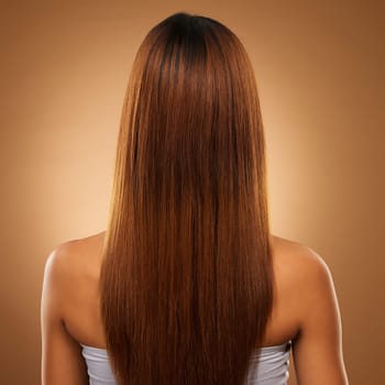 Back of hair, beauty and woman in studio for shampoo, wellness and keratin treatment on brown background. Hairdresser mockup, salon and girl with hairstyle for growth, haircare texture and cosmetics.