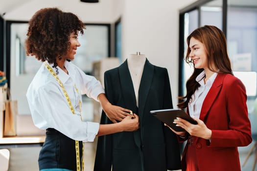 Multi ethnic young teen african american and asian woman fashion designer stylish and friend working at fashion Business studio.