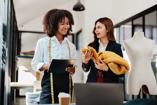 Multi ethnic young teen african american and asian woman fashion designer stylish and friend working at fashion Business studio.