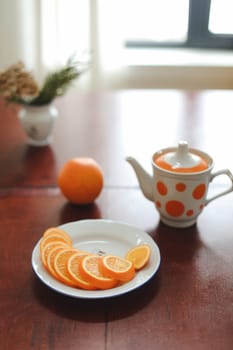 healthy breakfast, drink, orange slices on a plate on wooden table. detox diet concept, summer vitamin drinks